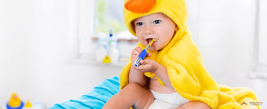 ADG-Baby in bath towel with tooth brush