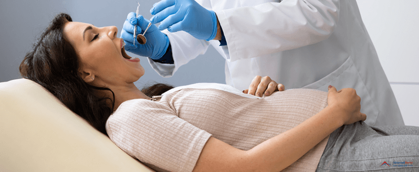 ADG-Dentist Treating Teeth Of Pregnant Woman Patient Lying