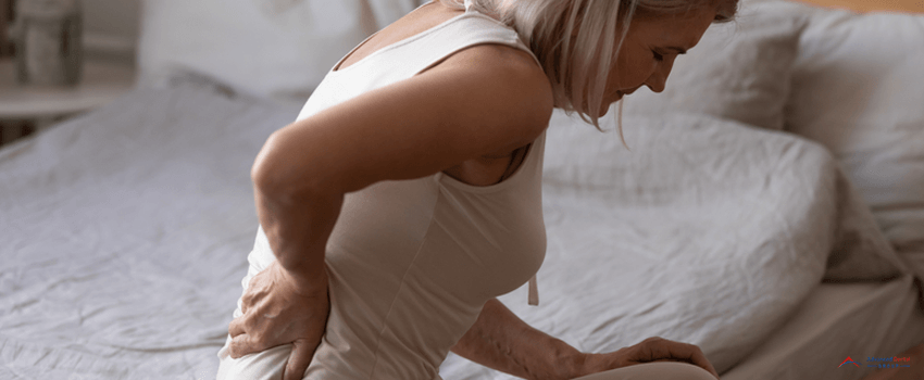 ADG-Upset mature woman suffering from backache, rubbing stiff muscles