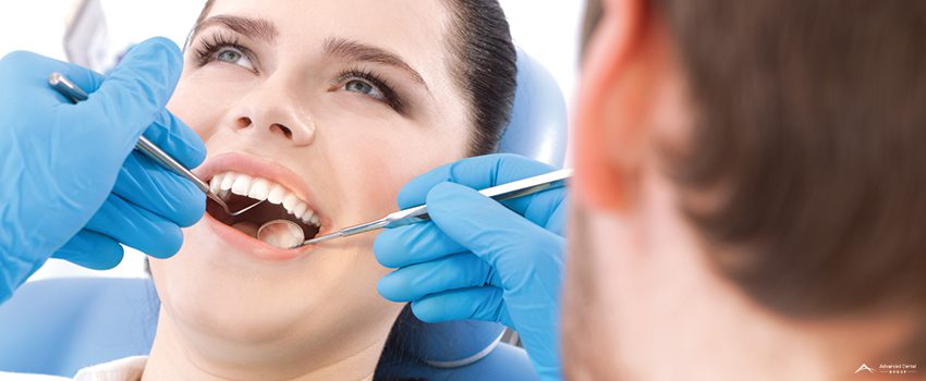 Dentist examines the oral cavity of patient